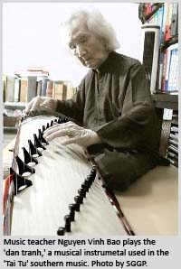 Music teacher Nguyen Vinh Bao plays the 'dan tranh,' a musical instrumetal used in the 'Tai Tu' southern music.