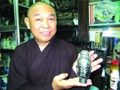 Da Nang monk Thich Tu Nghiem holds one of over 200 Buddhist statues.