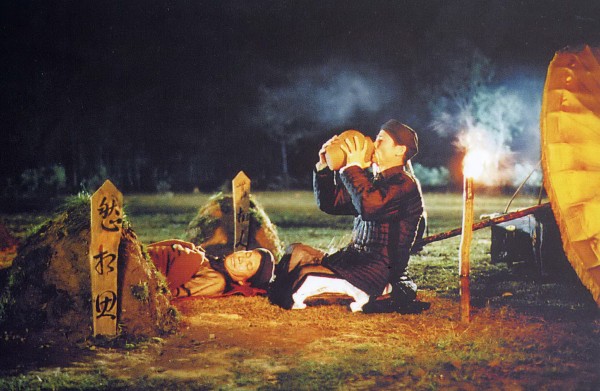 Master Nguyễn (right) has his last drink before setting fire to it all – his precious liquor jars stored in small mounds of earth, his loyal butler’s dead body, himself, and an old way of life 