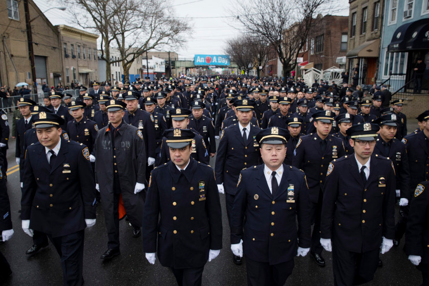 Police officers arrive to the funeral of New York Police Department Officer Wenjian Liu at Aievoli Funeral Home, Sunday, Jan. 4, 2015, in the Brooklyn borough of New York. Liu and his partner, officer Rafael Ramos, were killed Dec. 20 as they sat in their patrol car on a Brooklyn street. The shooter, Ismaaiyl Brinsley, later killed himself. (AP Photo/John Minchillo)