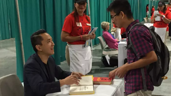 Viet Thanh Nguyen signing a book in Washington, DC.