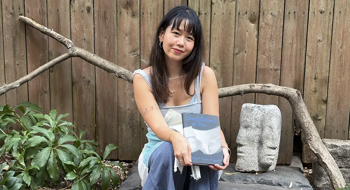Abbigail Rosewood holding her book Constellations of Eve